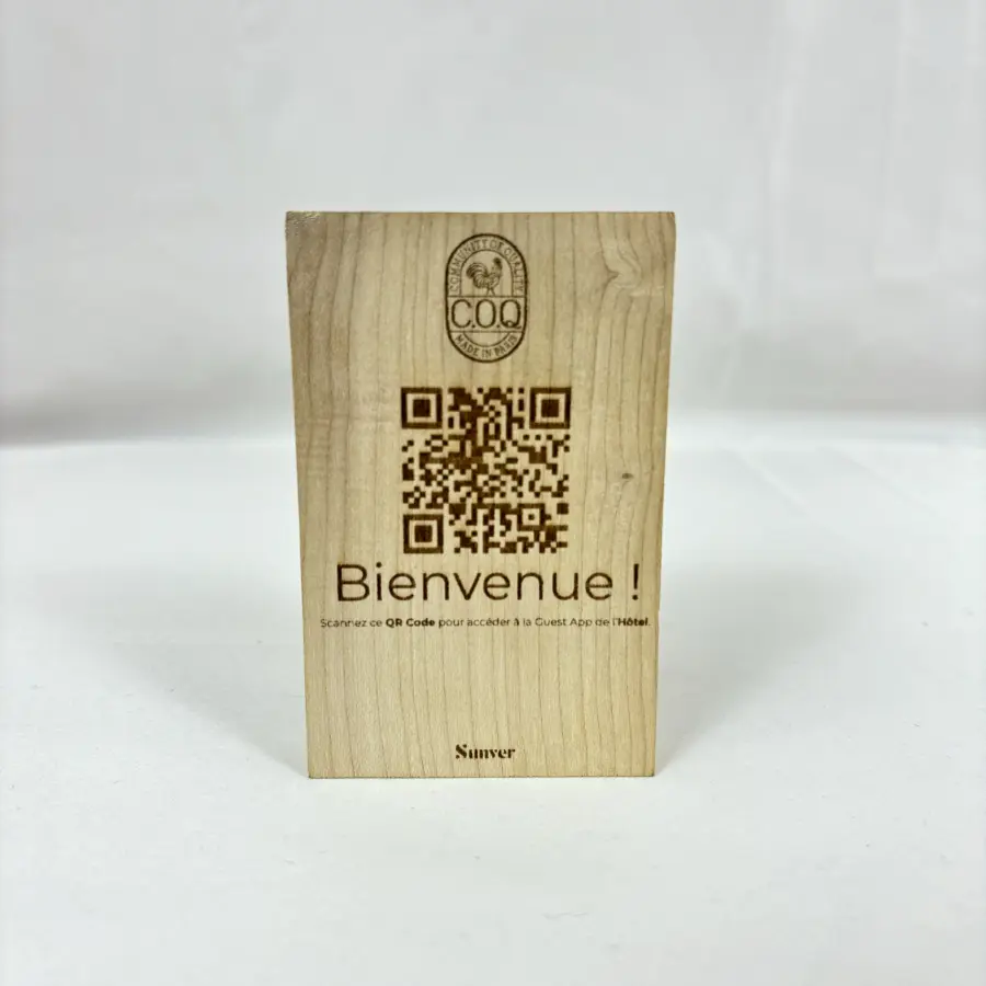 Photo of a vertical wooden QR code totem on an entrance console.