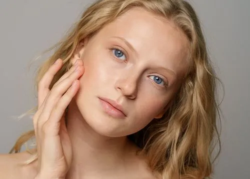 A woman touching her face