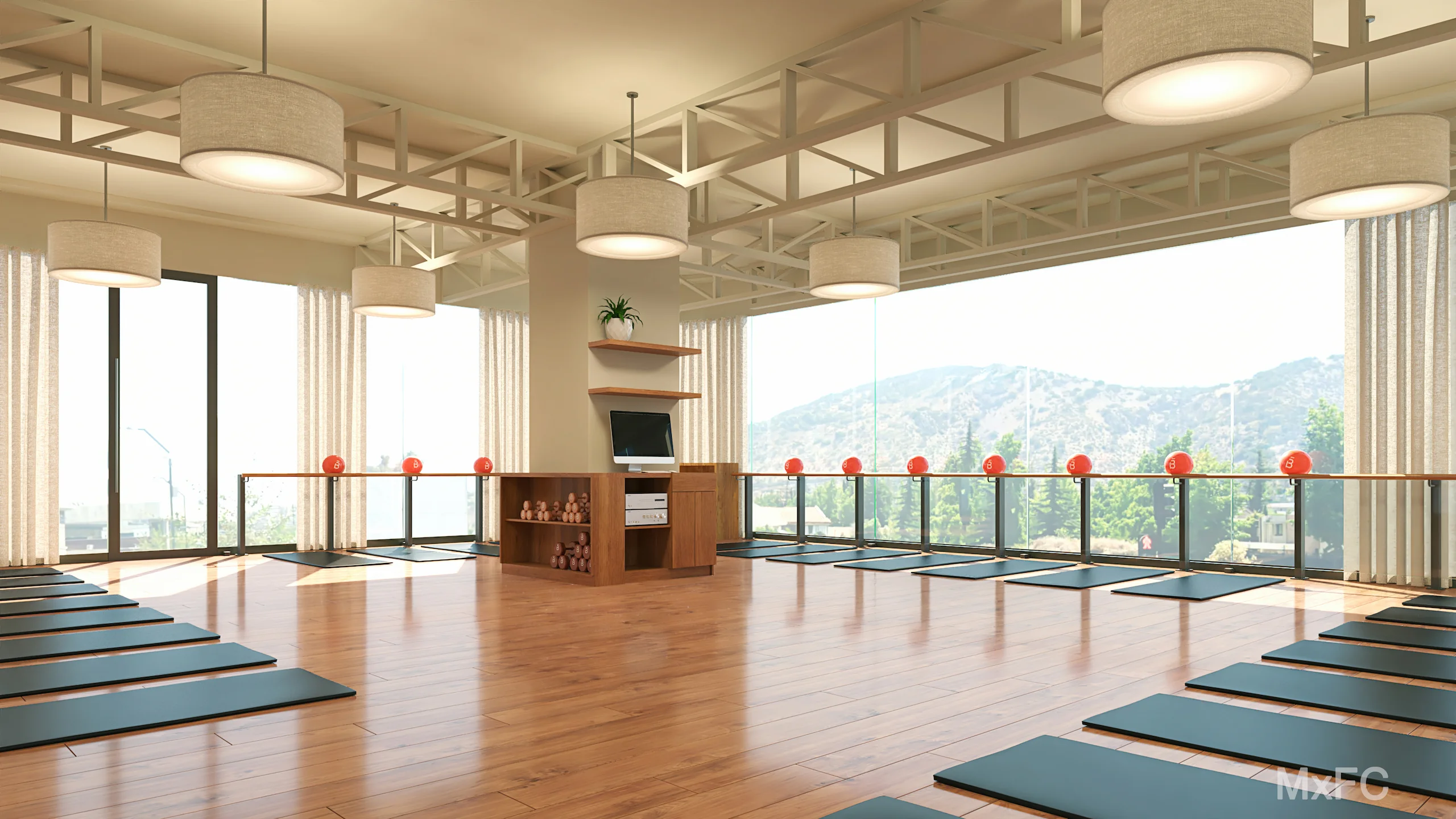 Amplio estudio de barre3 Santiago con suelo de madera, tapetes negros dispuestos alrededor del perímetro, grandes ventanales con vista a la montaña y lámparas colgantes redondas.