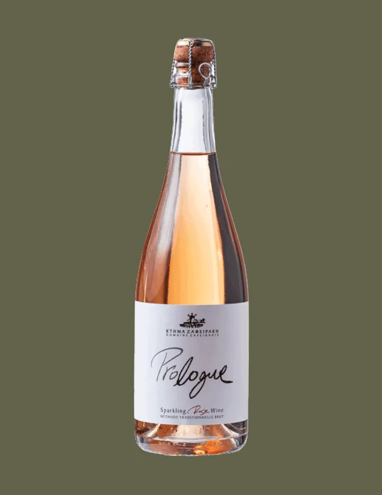 Bottle of Prologue sparkling rosé wine with cork and wire cage on olive green background.