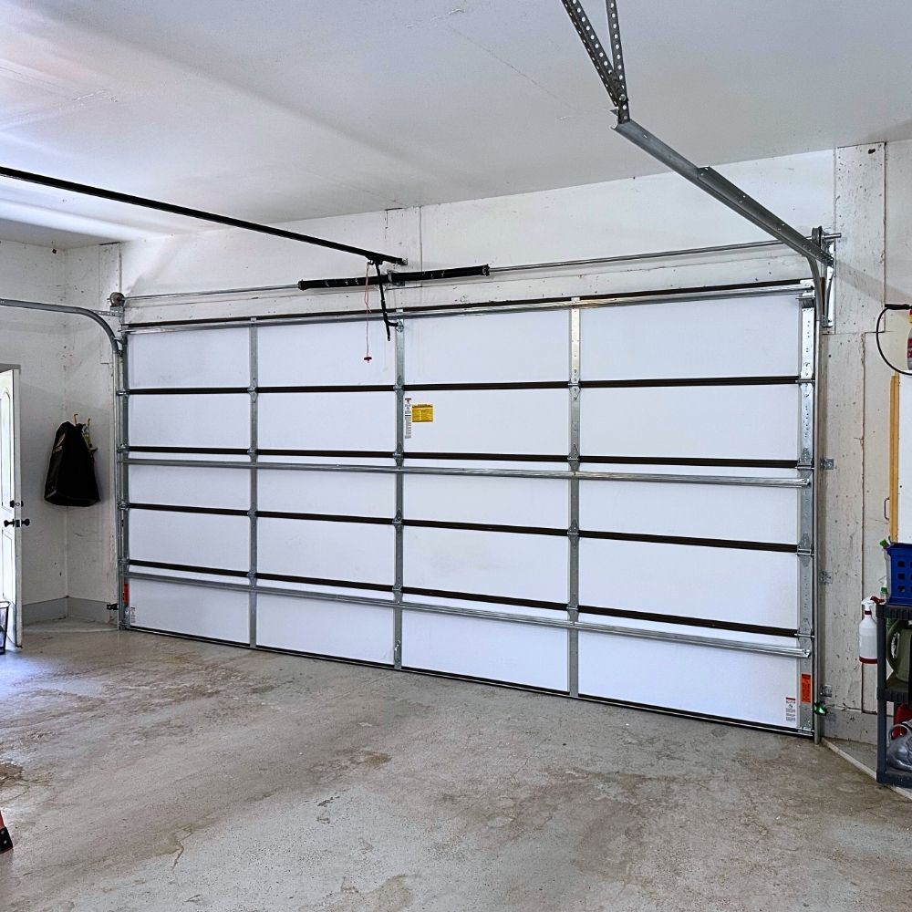 White aluminum garage door installed interior view