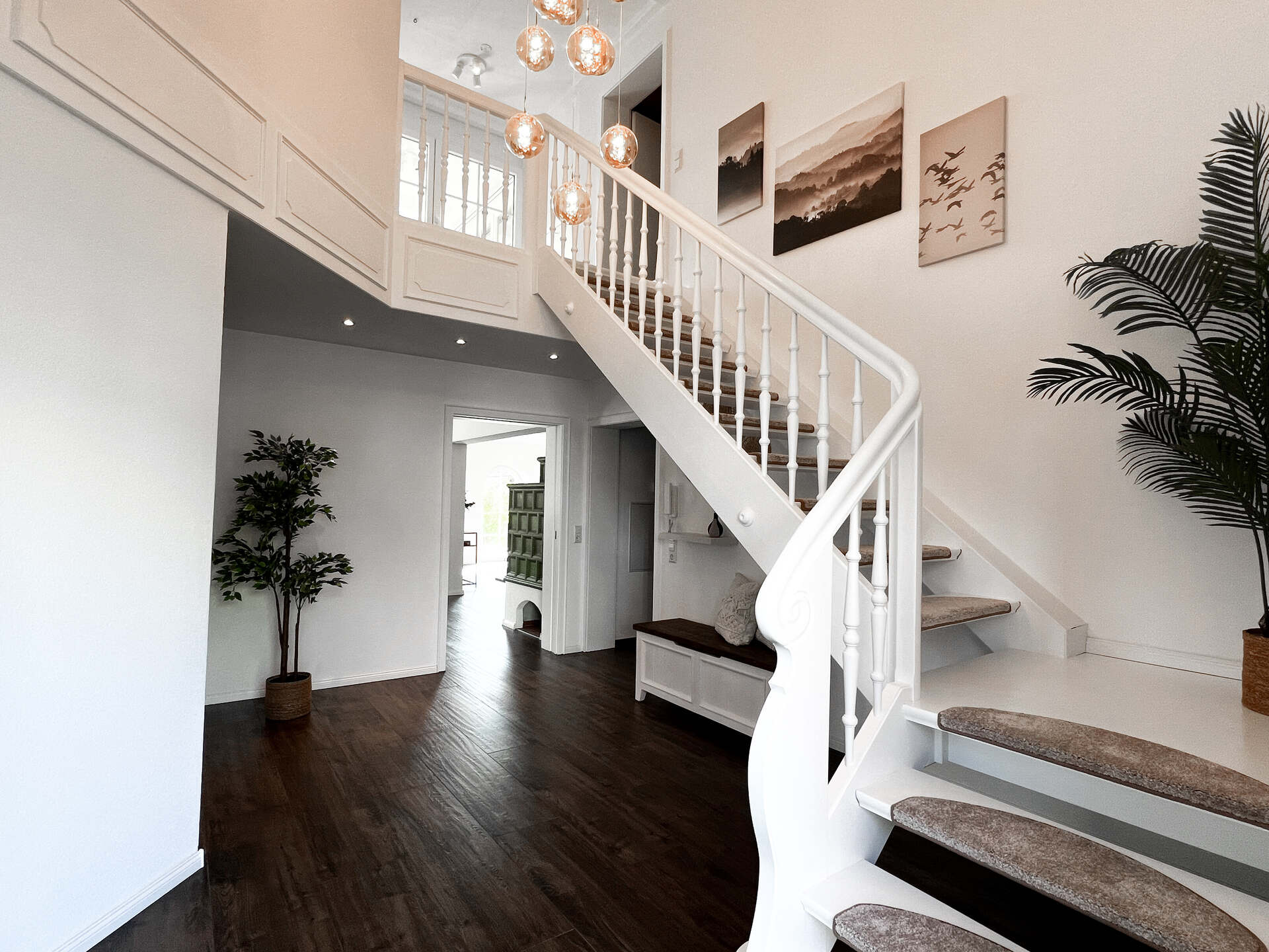 Heller Treppenaufgang mit weissen Holzgelaendern