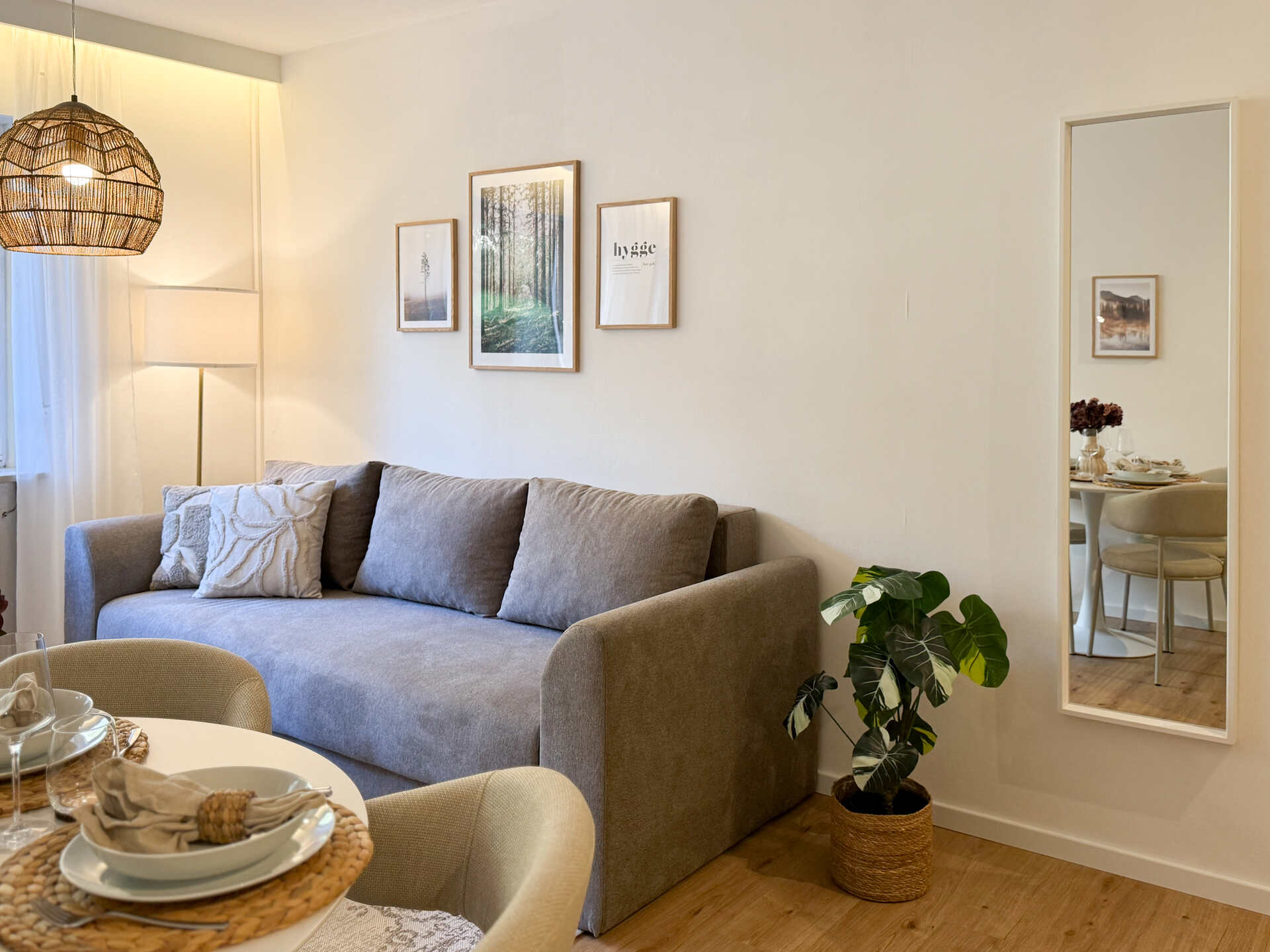 Sofa mit Wandbildern und Stehlampe