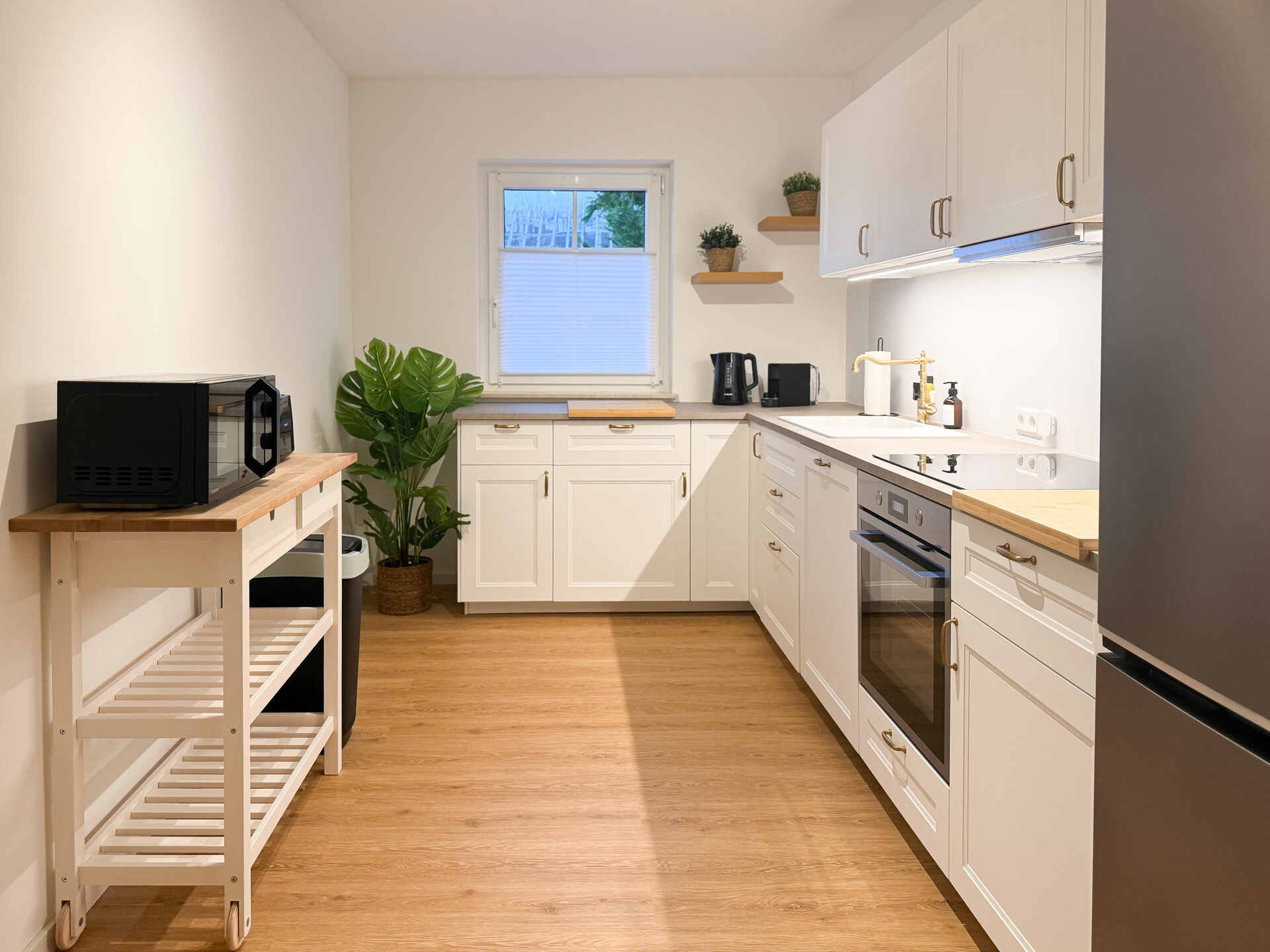 Helle Kueche mit Backofen und Fenster
