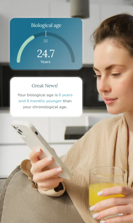 Woman holding a smartphone and a glass of orange juice, with a screen showing her biological age as 24.7 years, which is 6 years and 8 months younger than her chronological age.