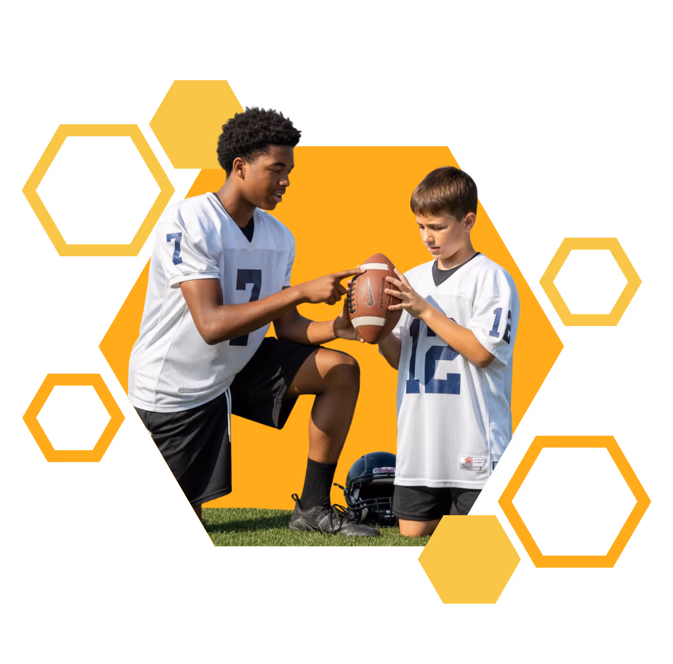 An athlete coaching a kid on football.