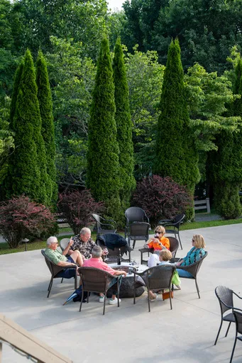 group of people eating around a firepit