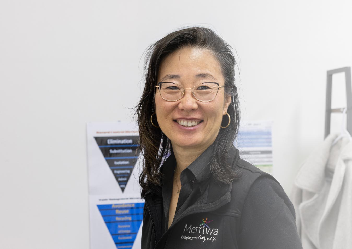 A picture of a lady looking at the camera smiling.