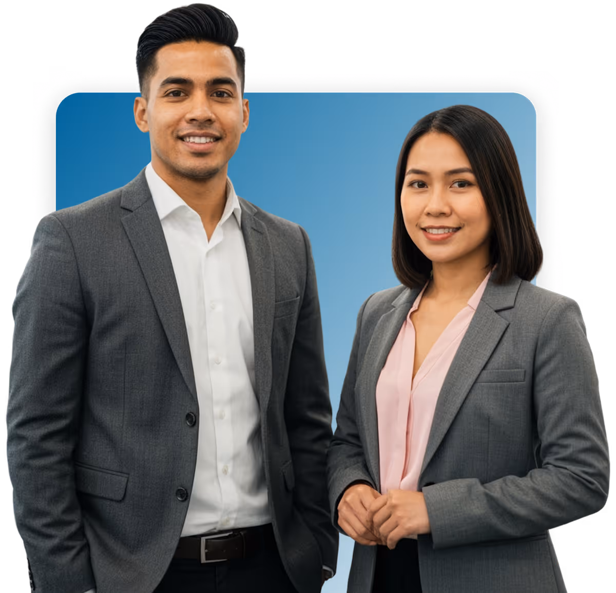 Smiling man and woman dressed in gray business suits standing side by side against blue background.
