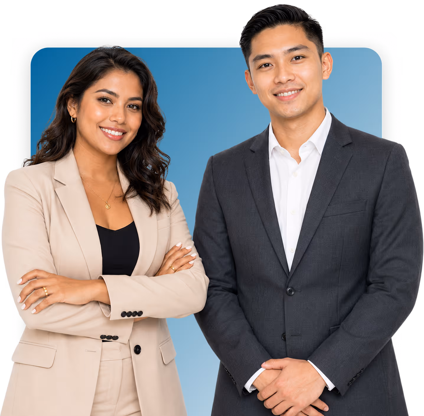 Smiling businesswoman in beige suit and businessman in dark suit standing with crossed arms against blue background.