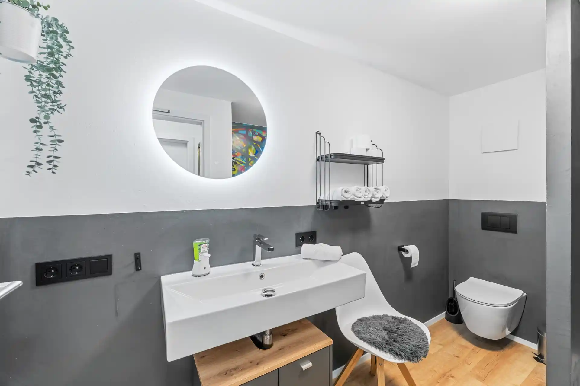 Badezimmer mit Waschbecken und Spiegel im Ferienhaus Die 16 Rosenfeld