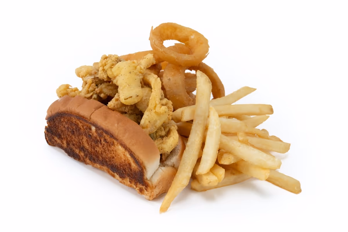 A fried clam roll in a toasted bun served with French fries and onion rings on a white background.