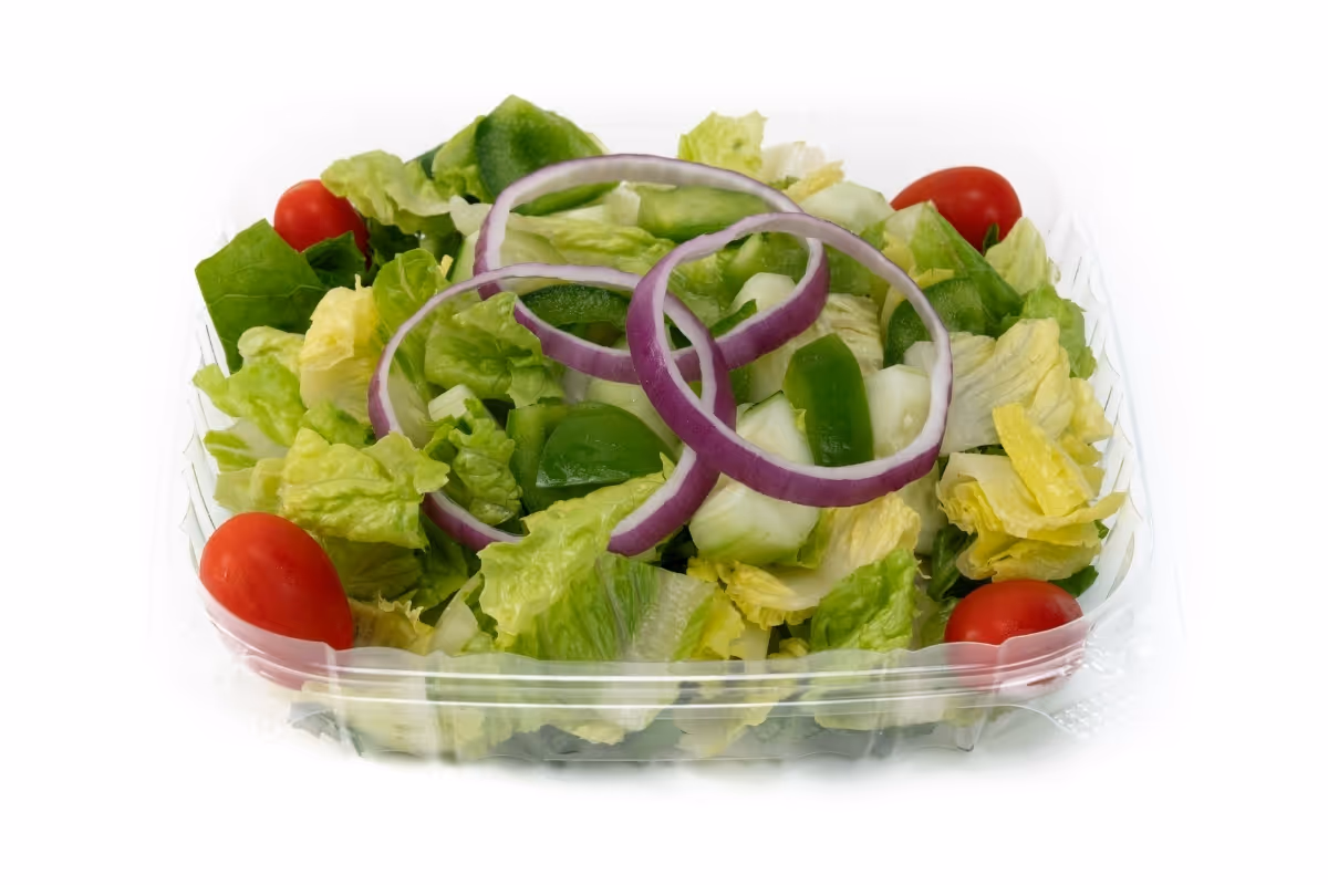 Clear plastic container with a salad of lettuce, grape tomatoes, green bell pepper, cucumber, and red onion rings.