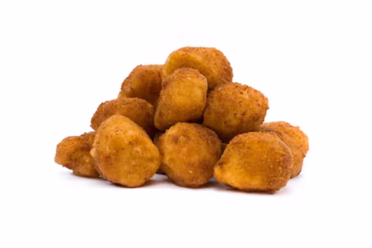 A pile of golden-brown, breaded and fried scallops on a white background.