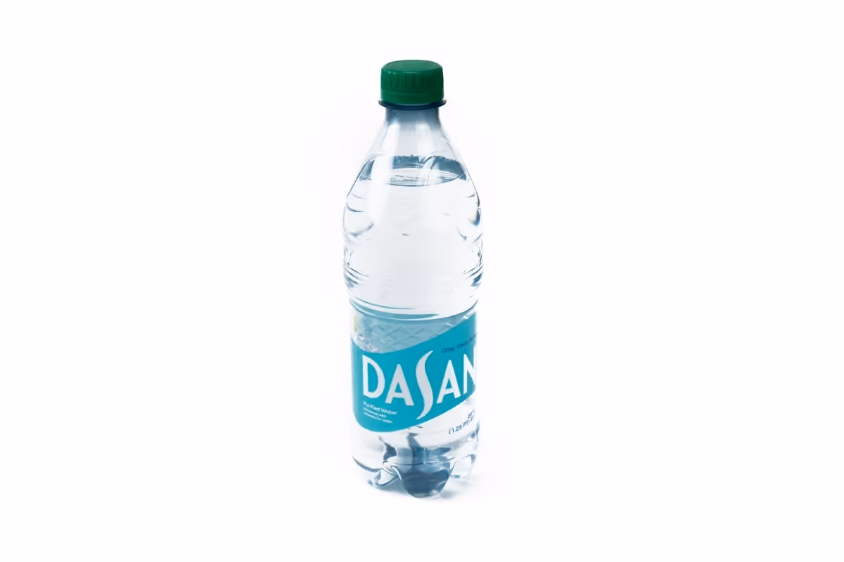A plastic bottle of Dasani water with a green cap on a white background.