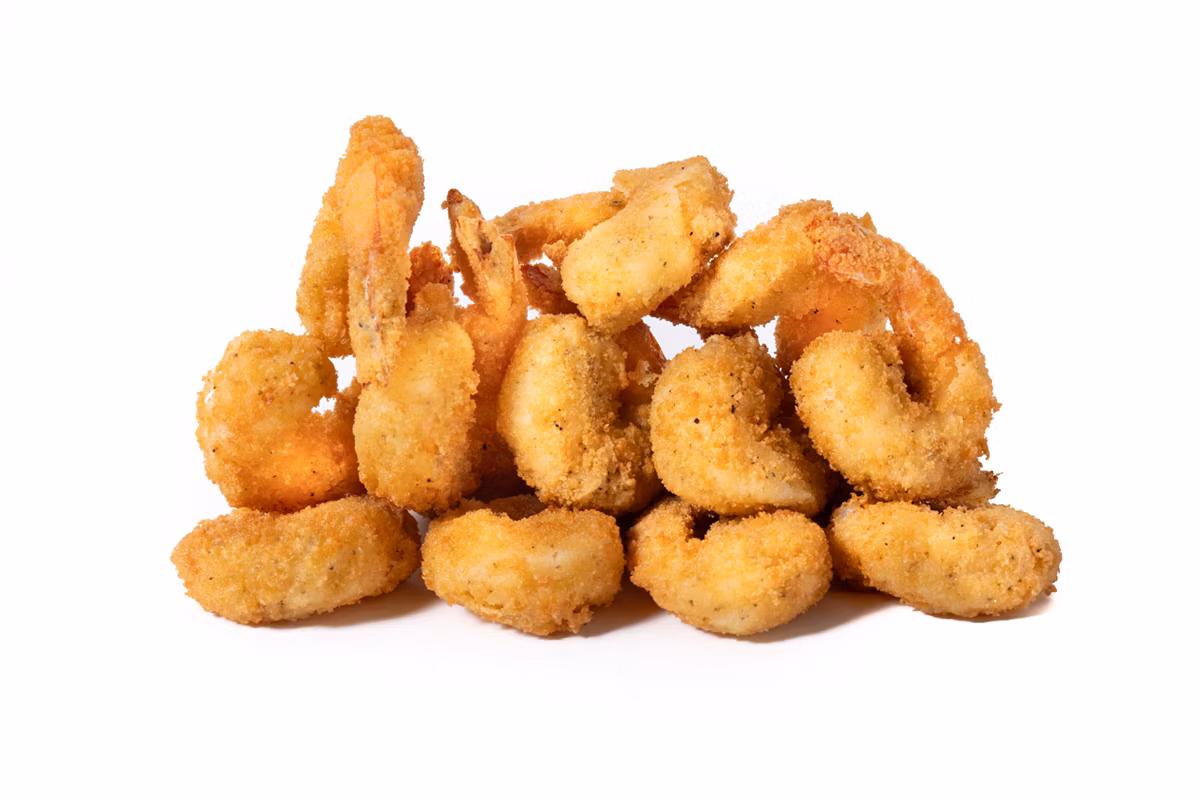 A pile of breaded, deep-fried shrimp on a white background.