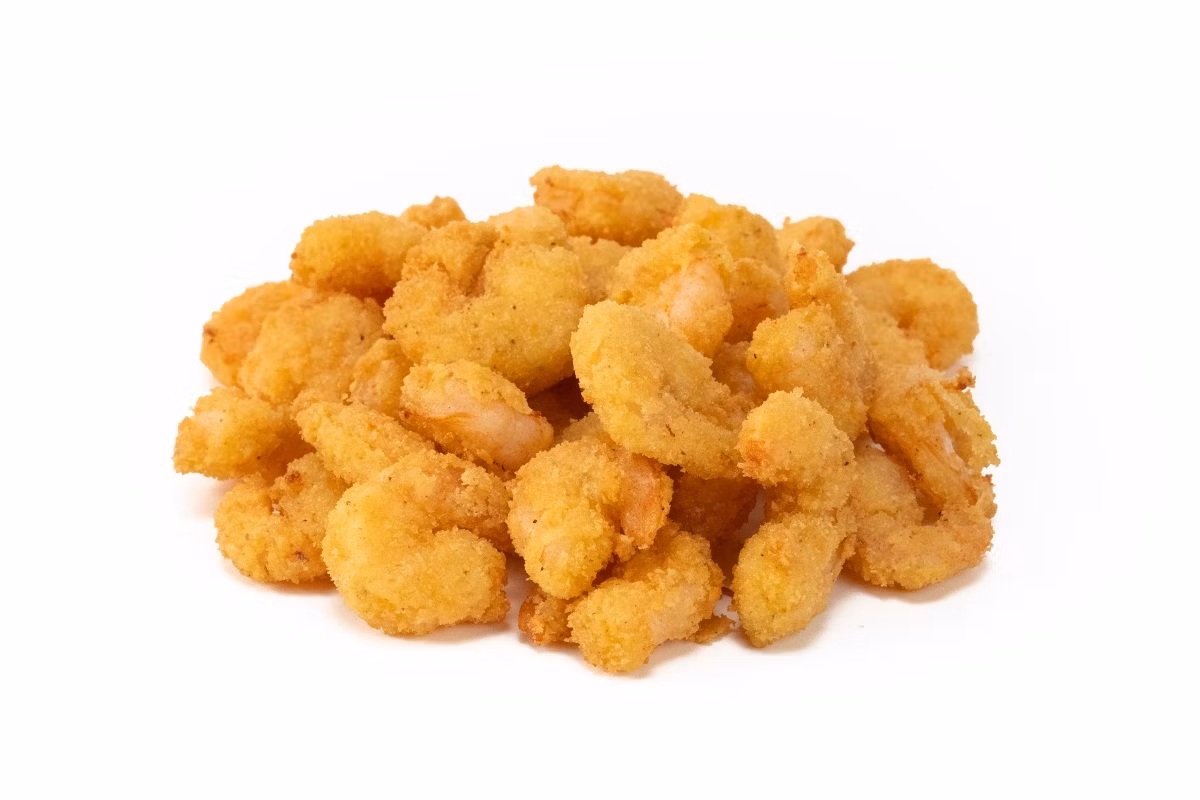 A pile of breaded and fried shrimp on a white background.