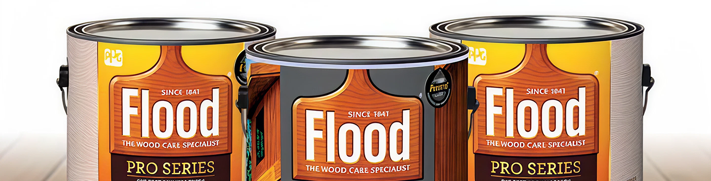 Three cans of Flood Pro Series wood care product arranged side by side on a wooden surface.