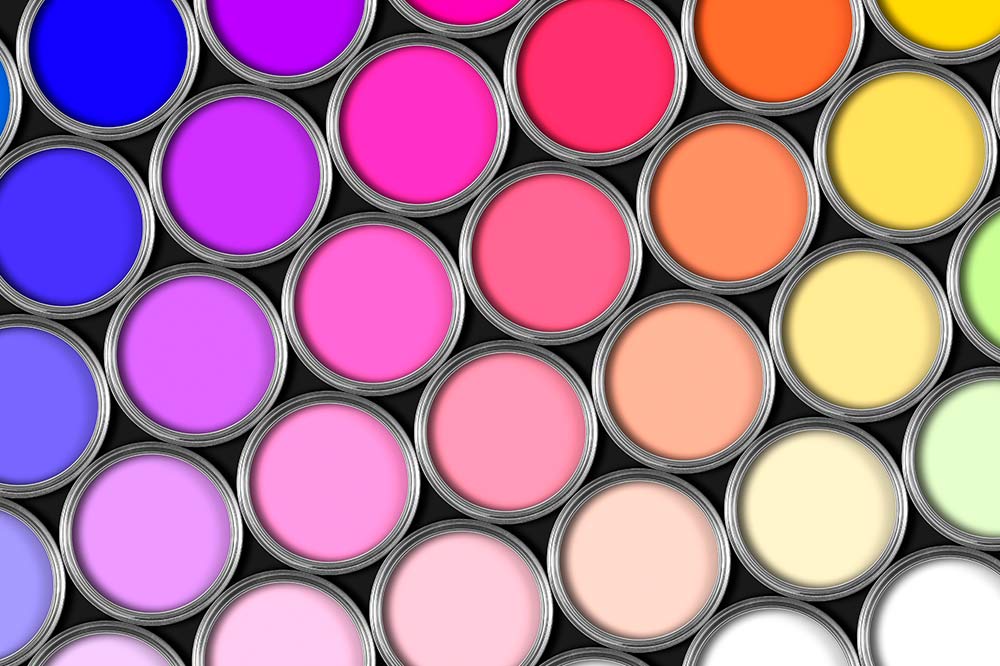 Open paint cans arranged closely with vibrant colors including shades of blue, purple, pink, orange, yellow, and white.