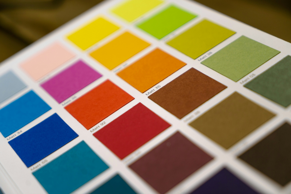 Close-up of a color palette with various matte color swatches displayed in rows on a white sheet.