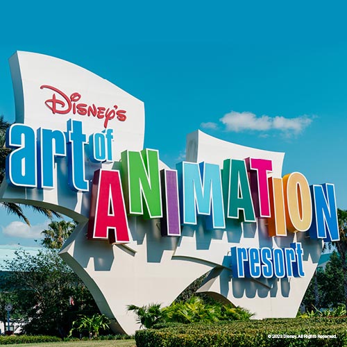 Colorful sign for Disney's Art of Animation Resort against a blue sky with greenery below.