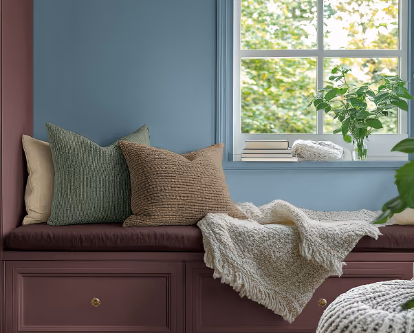 Cozy interior window seating with blue-grey walls