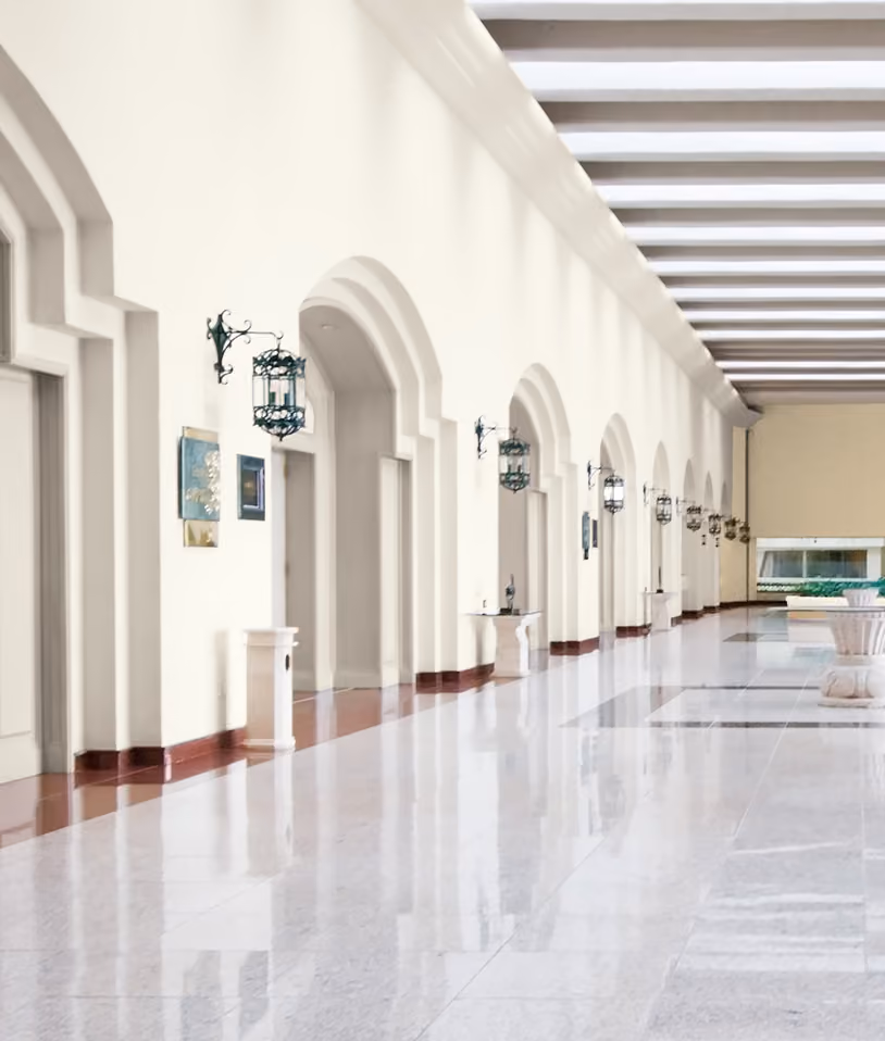 White painted arched hallway with hanging lanterns