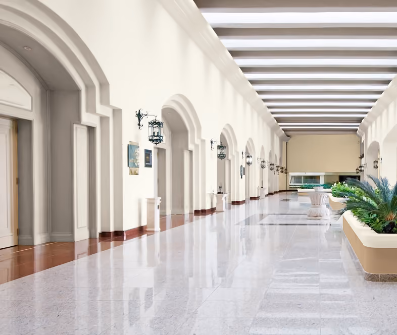 White painted arched hallway with hanging lanterns