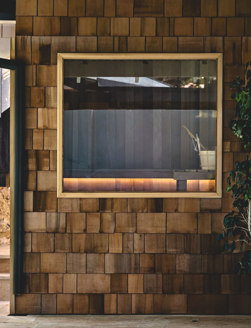 Outdoor cedar sauna pavilion with glass front, designed for Perth climate