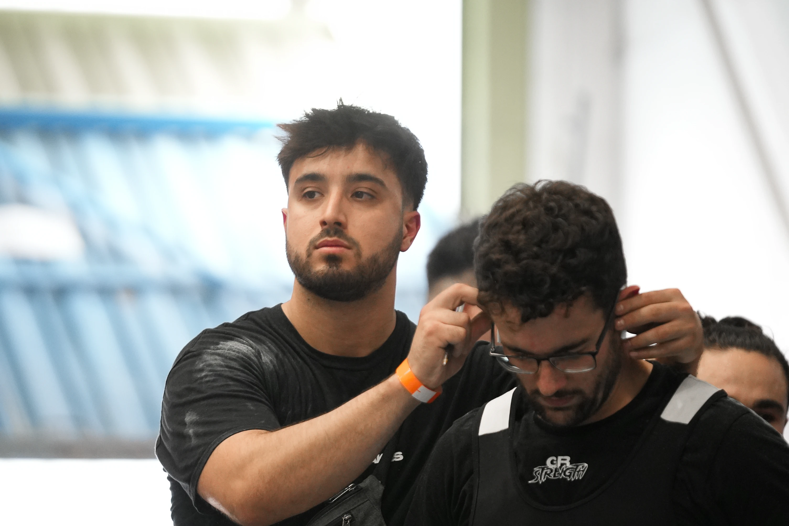 GRS coach with an athlete in a powerlifting competition