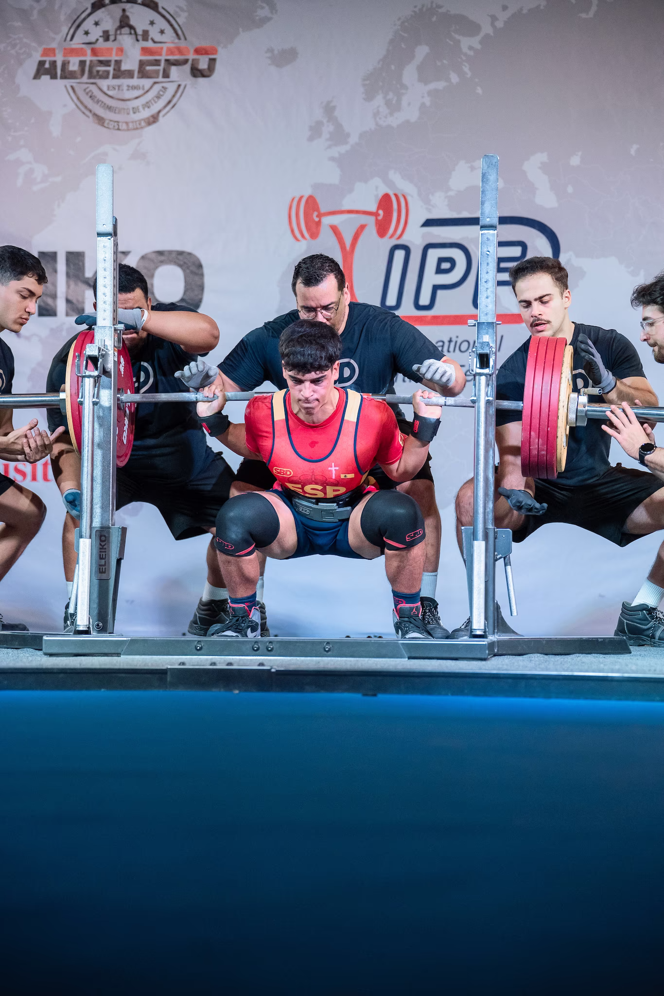 athlete doing a squat in a IPF powerlifting championship