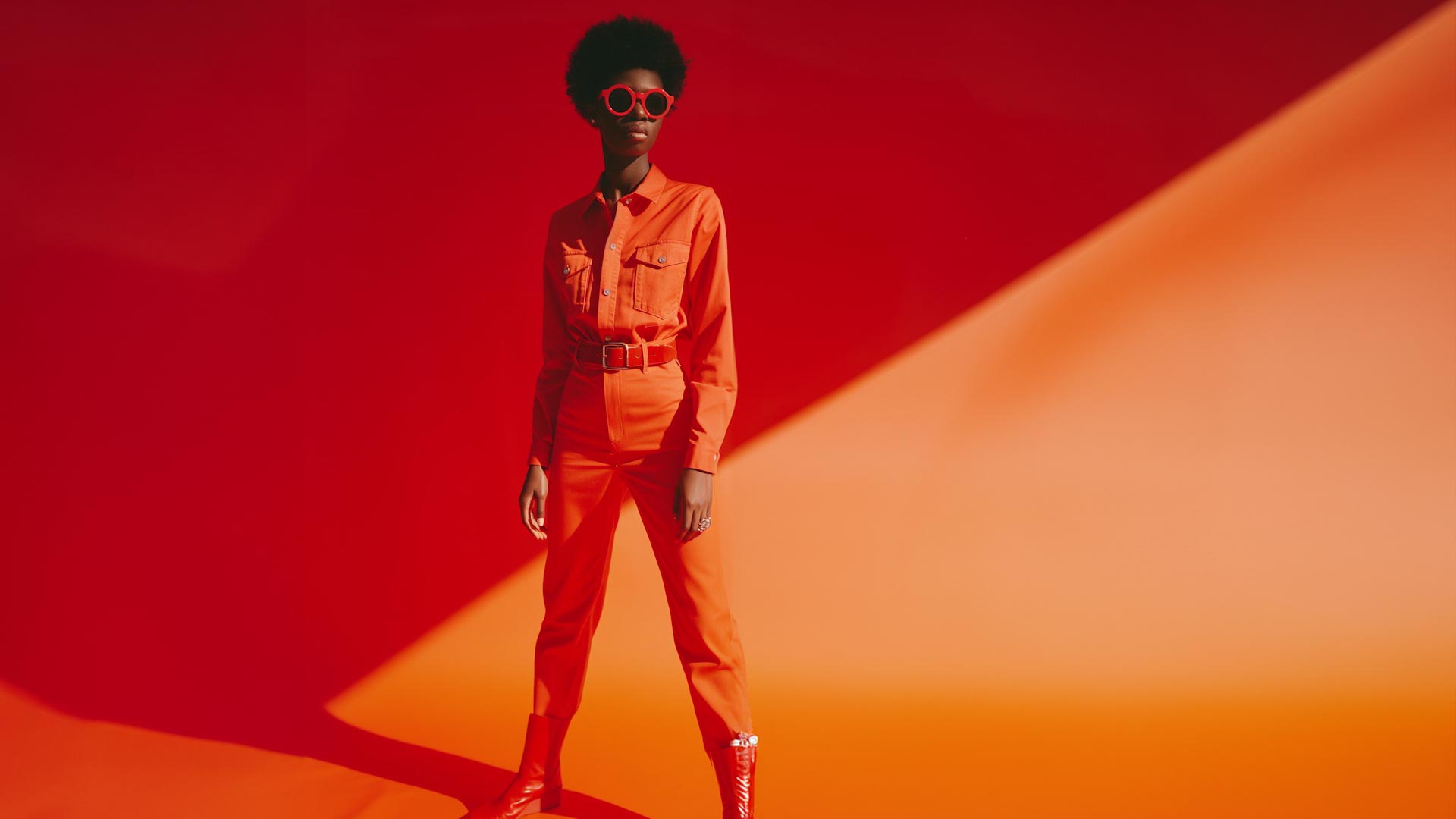 Young woman on red-orange background.