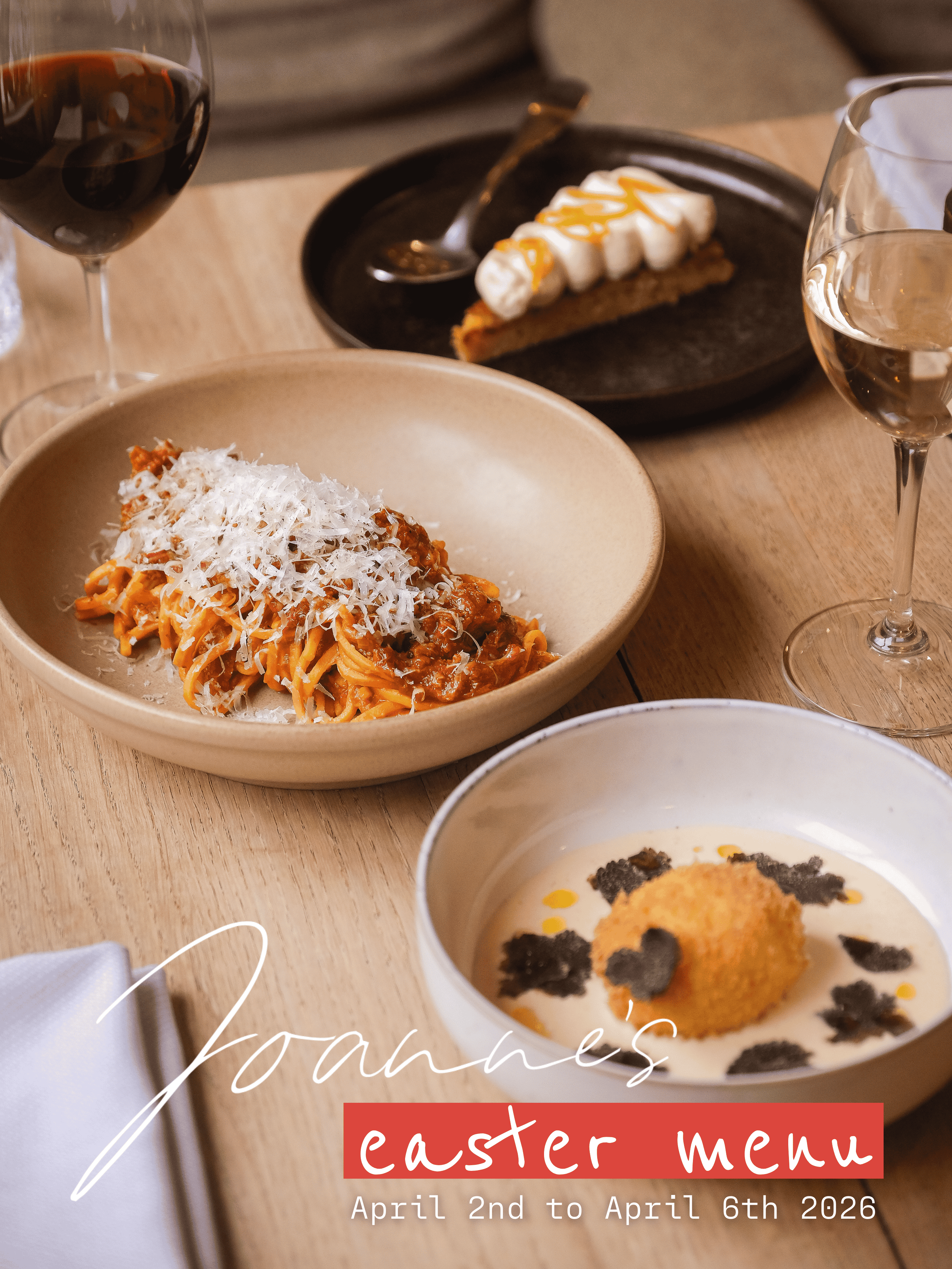Plate with two slices of medium-rare beef, a serving of orange puree, and greens, with out-of-focus drinks and food in the background.