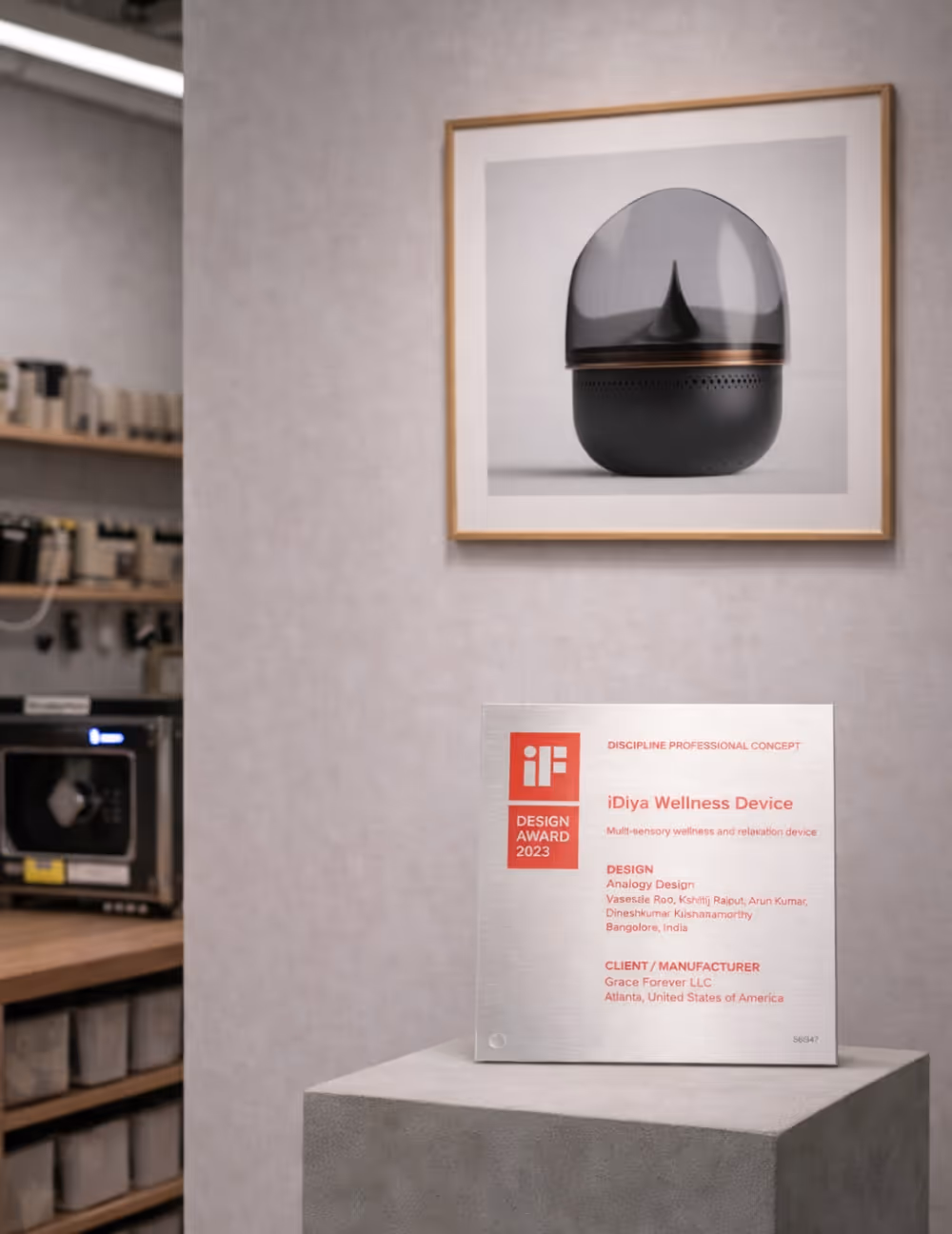 iF Design Award 2023 plaque for the iDiya Wellness Device, a multi-sensory wellness and relaxation device, displayed on a pedestal with a framed image of the device above it.
