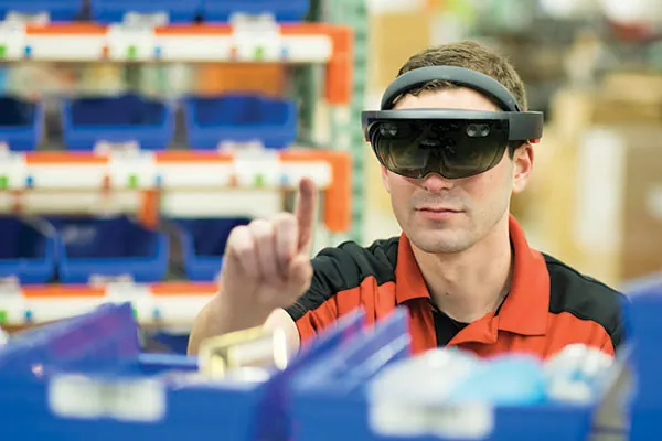A factory worker using an AR headset on the production floor