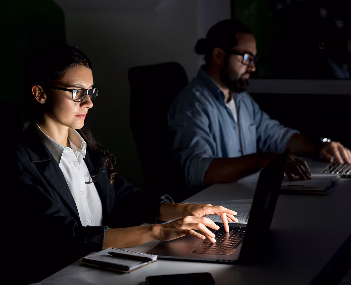 a woman and man working on a laptop