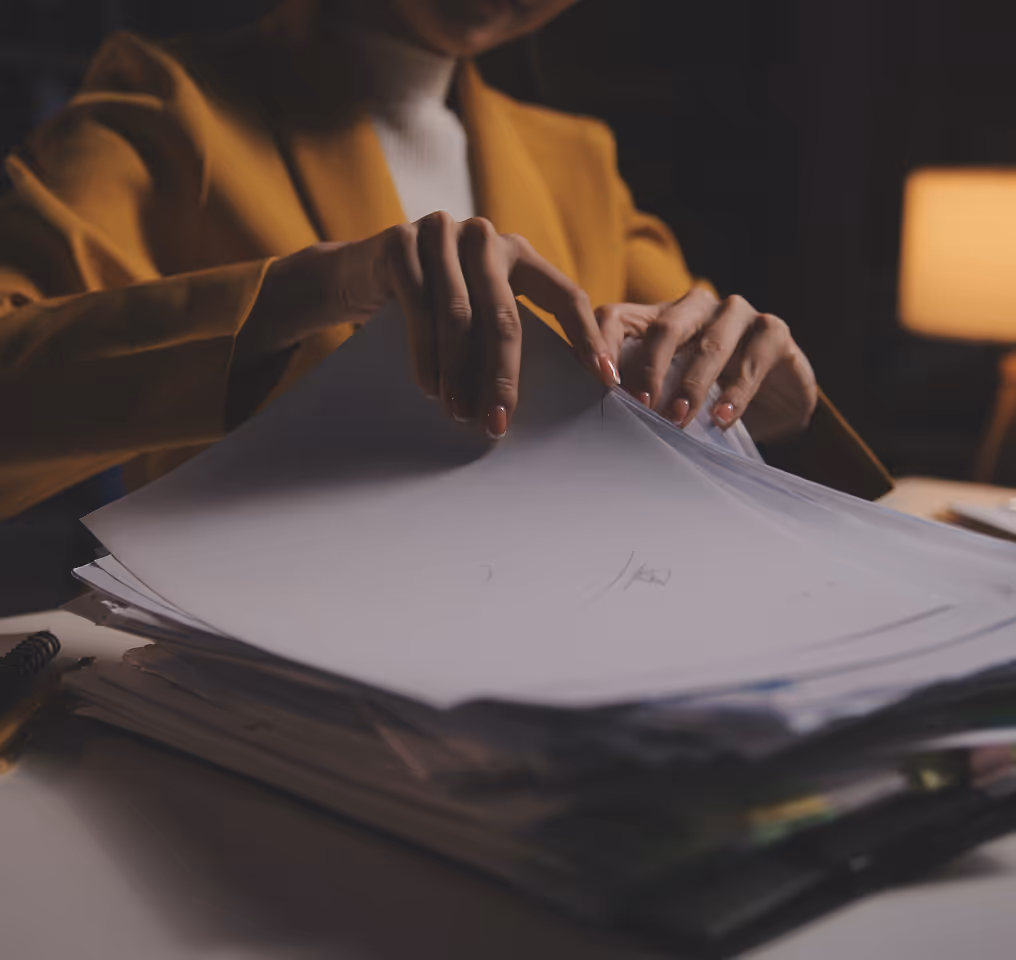a woman holding a stack of papers