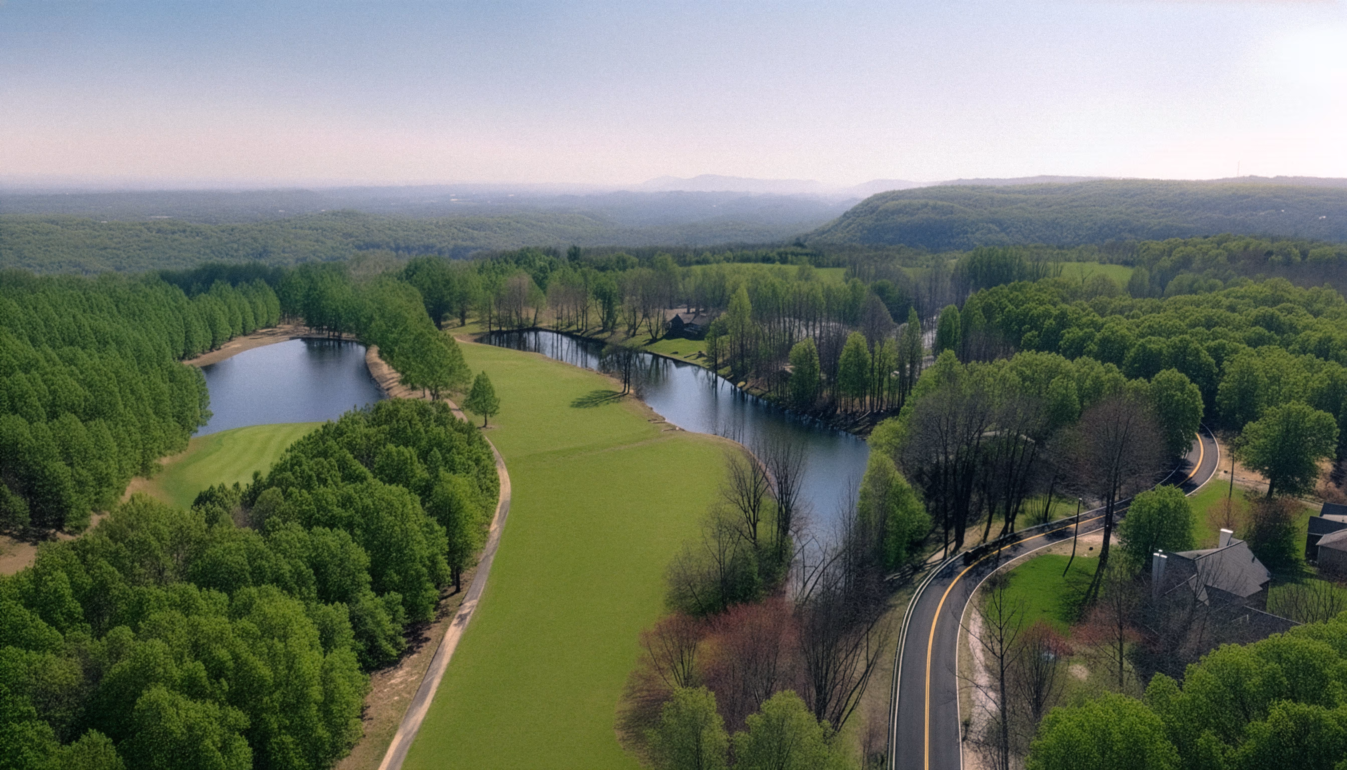 Drone view of Montlake Golf Course in Soddy-Daisy, Tennessee, featuring green fairways, ponds, and wooded hills.