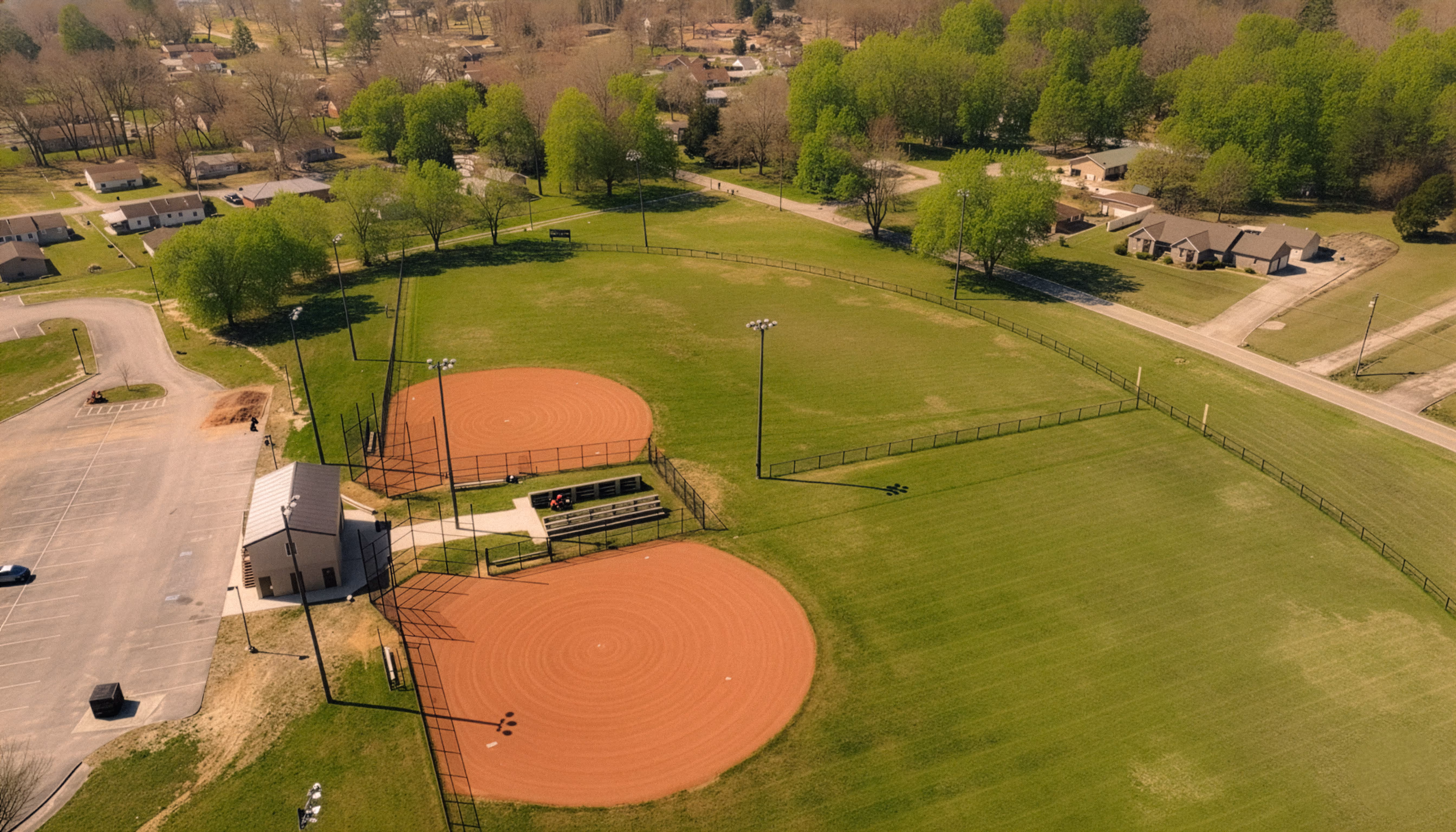 Aerial shot of the baseball fields at Veterans Park in Soddy-Daisy, Tennessee, showing two diamonds, open fields, and nearby neighborhood areas.