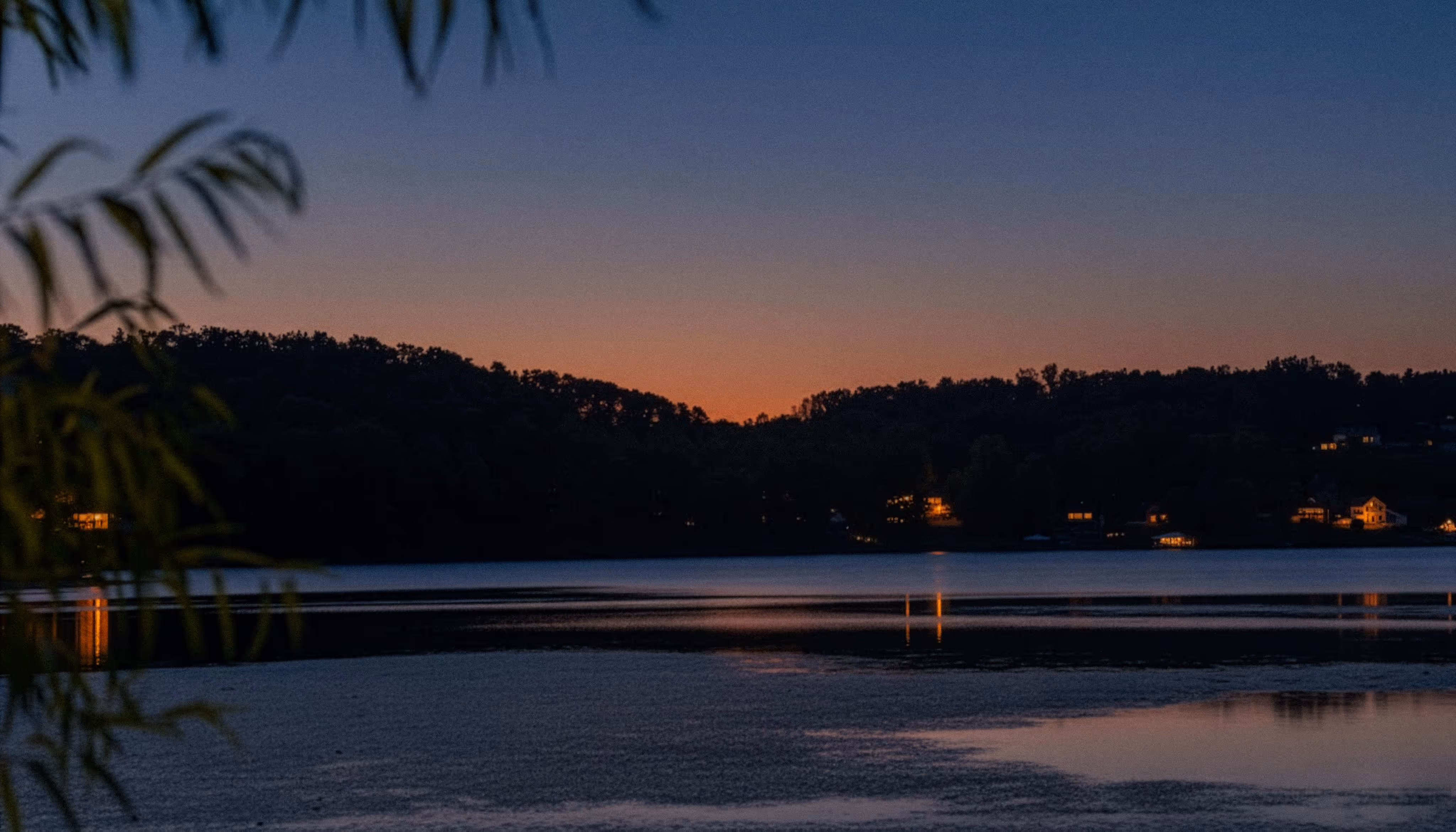 Evening photo of Soddy Lake in Soddy-Daisy, Tennessee, taken near Highway 27 with calm water and a darkened treeline.