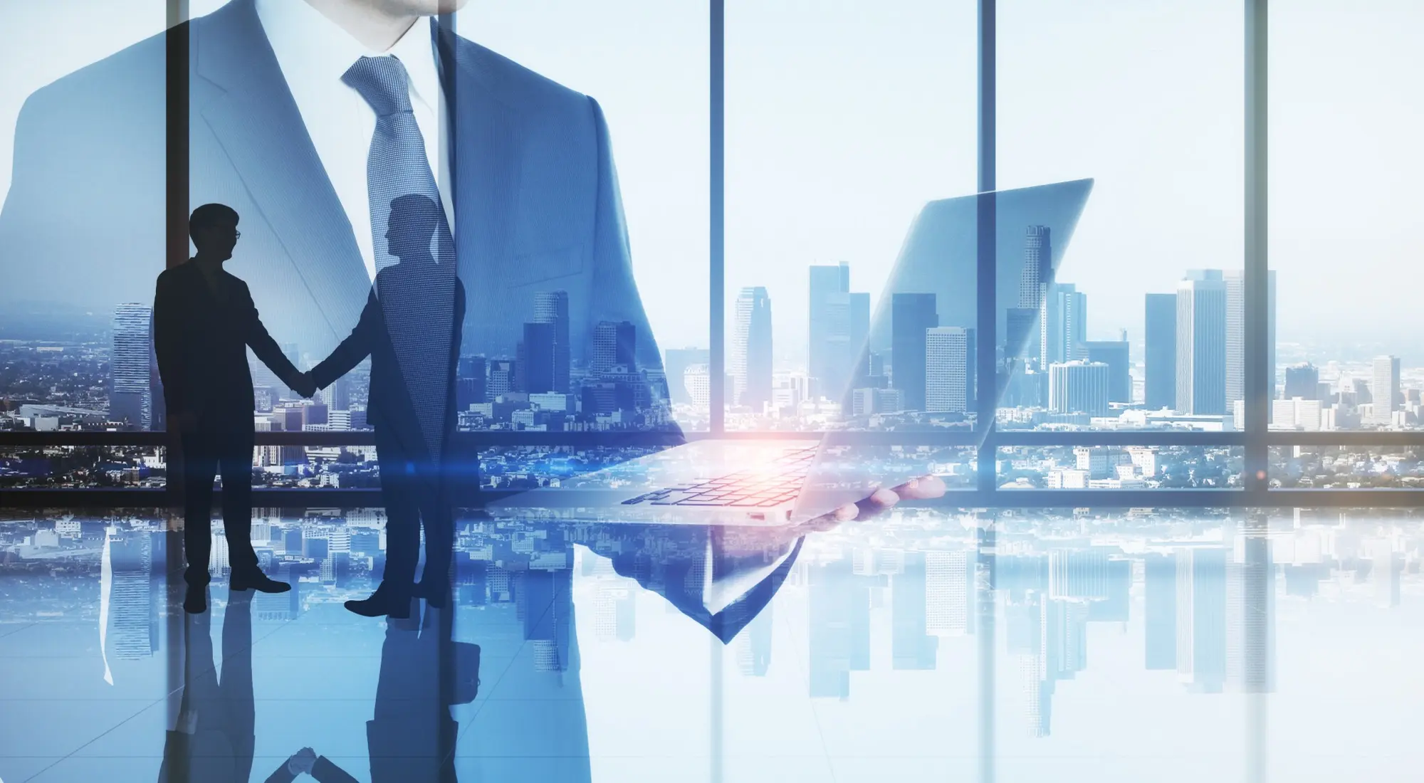 Immagine concettuale di business con doppia esposizione: uomo d'affari con laptop, stretta di mano e skyline cittadino sullo sfondo