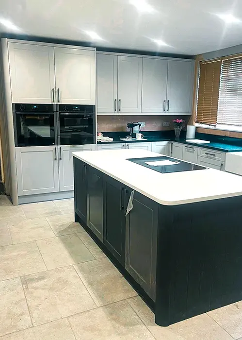 Modern kitchen with white worktops and grey and black cabinets
