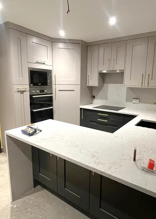 Grey kitchen with white worktops