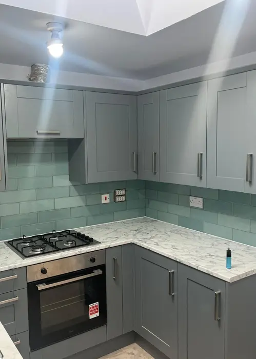 Grey kitchen with green tiles