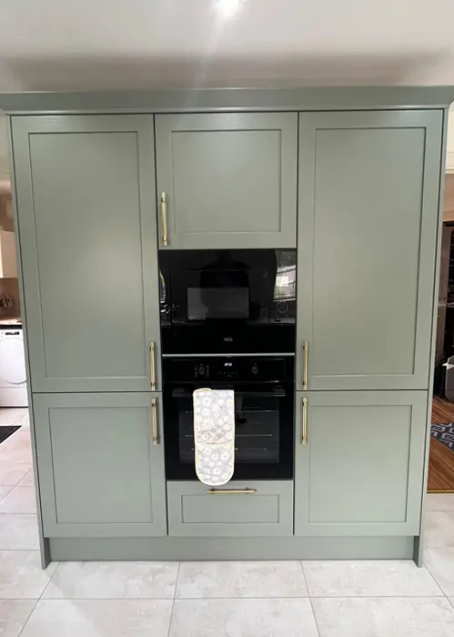 Cooker inbuilt into Sage green kitchen