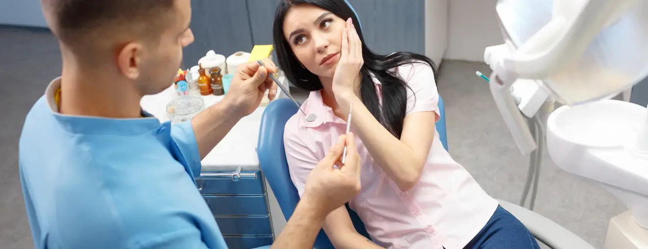 A woman is getting a shot from a man.