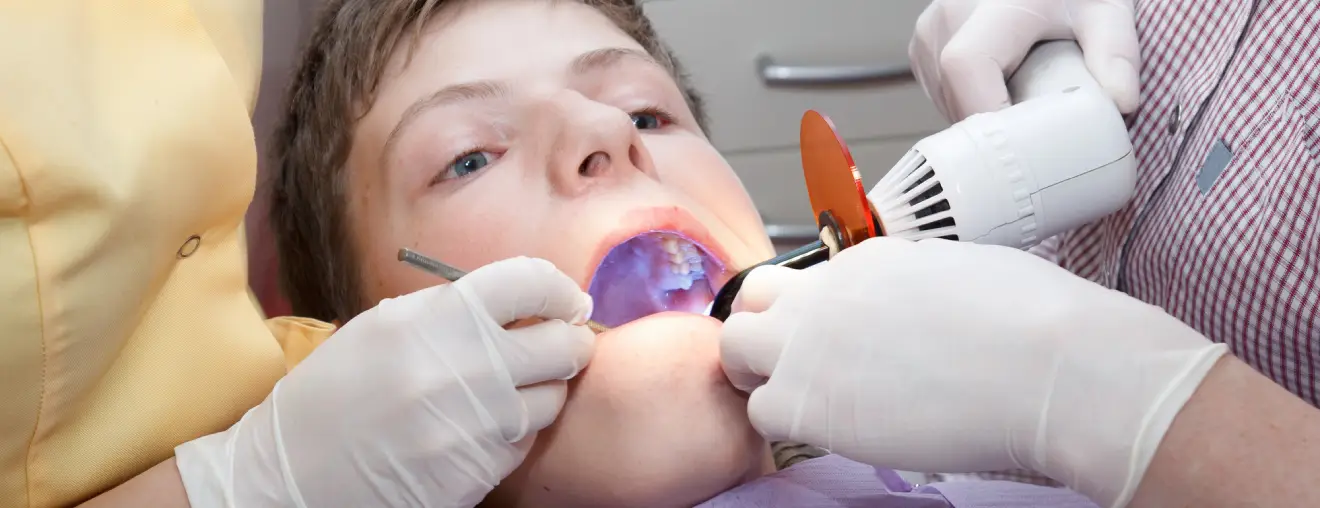 A person getting dental sealants installed