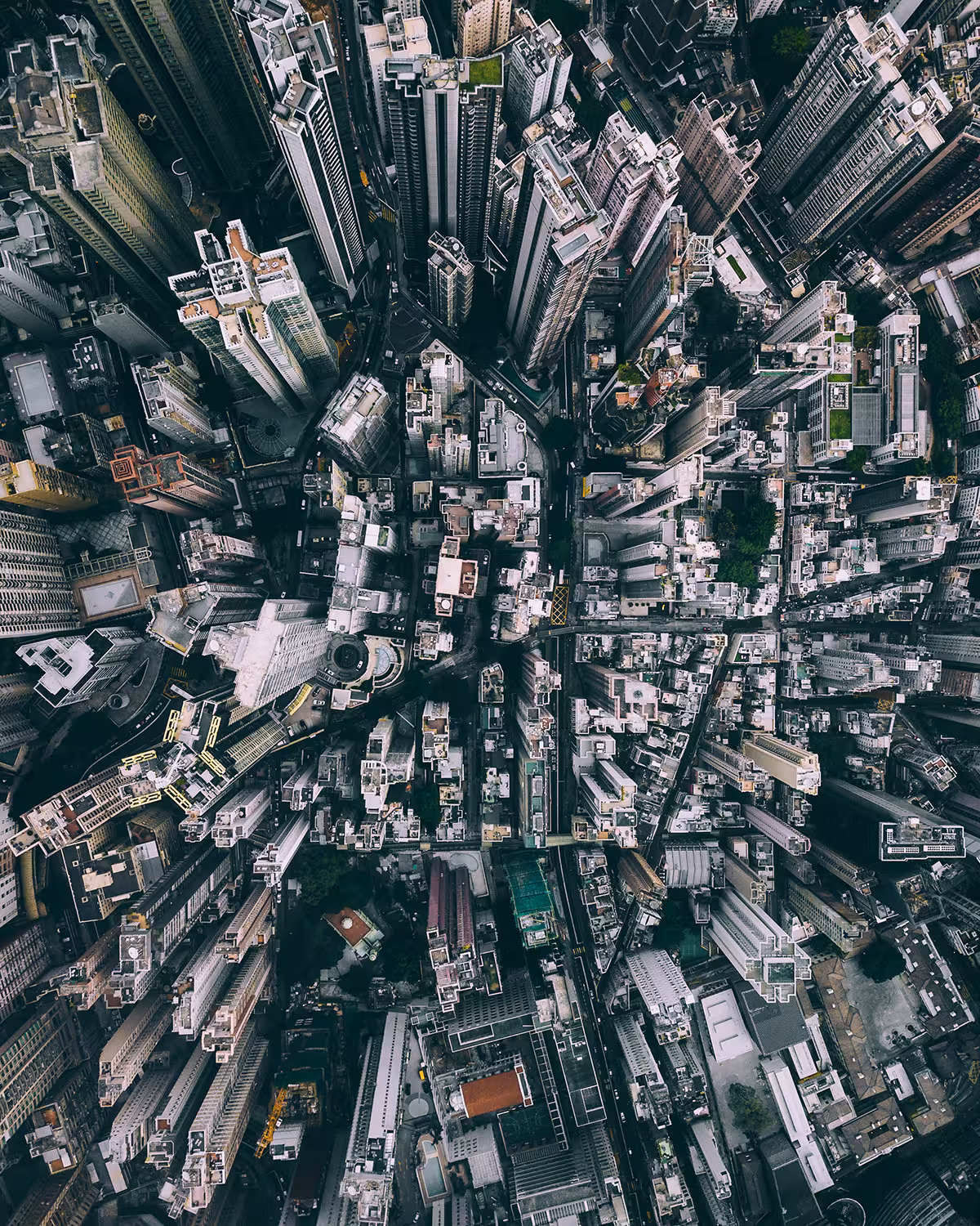 Aerial view of a built-up metropolitan area, filled with roads and high-rise buildings. 
