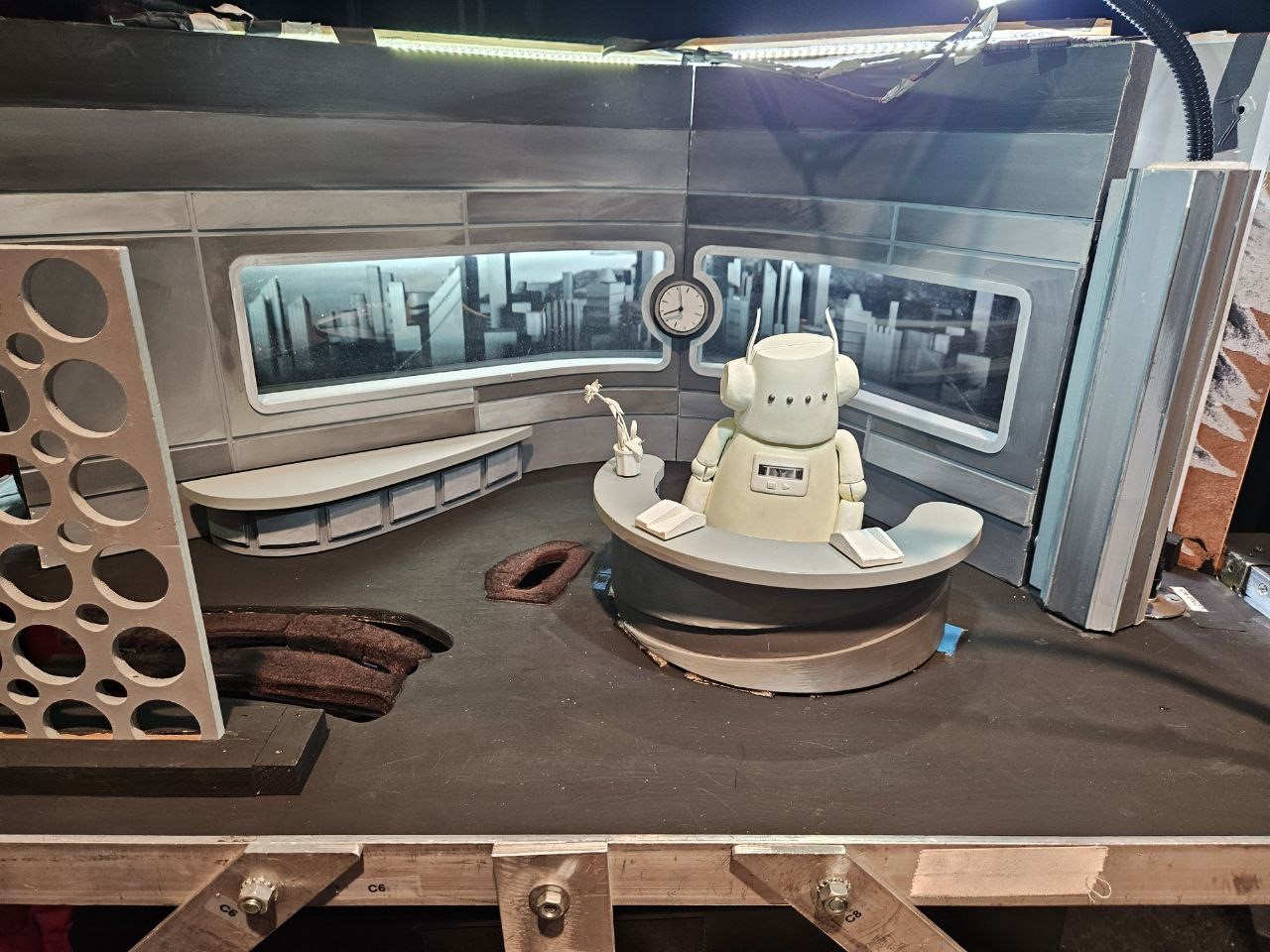 A robot sitting in a roomDescription automatically generated