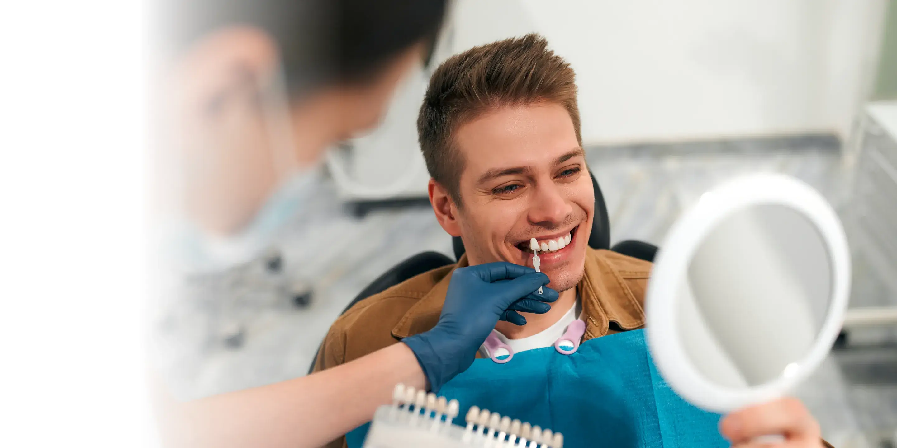 A man brushing his teeth in front of a mirror.